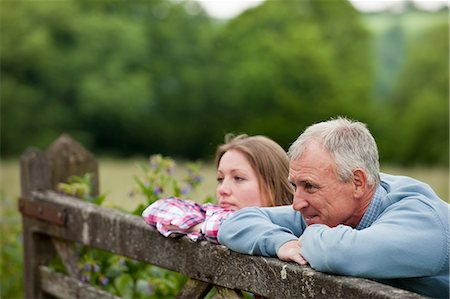 senior man introspective - Father and daughter on wooden fence Stock Photo - Premium Royalty-Free, Code: 649-06304853