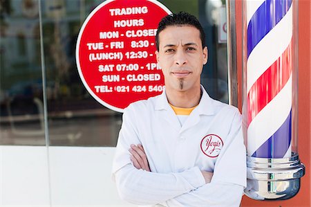 Barber standing outside shop Stock Photo - Premium Royalty-Free, Code: 649-06305052