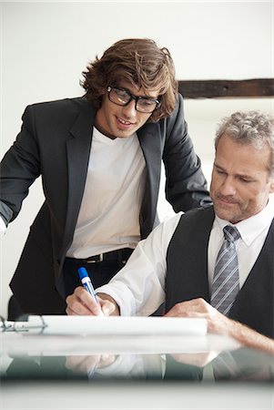 simsearch:649-06305244,k - Businessmen working together in office Stock Photo - Premium Royalty-Free, Code: 649-06305224