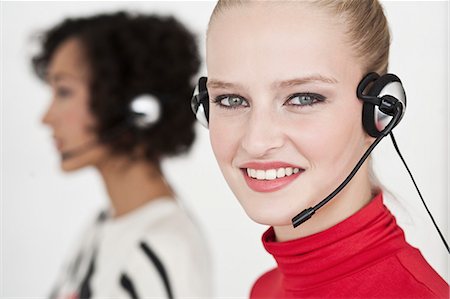 person standing and talking on phone - Businesswomen wearing headsets Stock Photo - Premium Royalty-Free, Code: 649-06305286