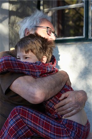 simsearch:649-06305342,k - Older man hugging grandson outdoors Stock Photo - Premium Royalty-Free, Code: 649-06305333