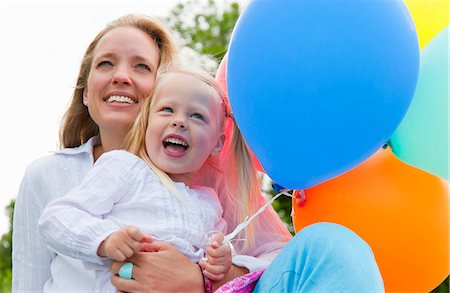 family of five hugging - Mother and daughter holding balloons Stock Photo - Premium Royalty-Free, Code: 649-06305410