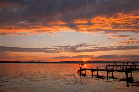 dock, sunset - Sun setting over still rural lake Stock Photo - Premium Royalty-Free, Code: 649-06305430