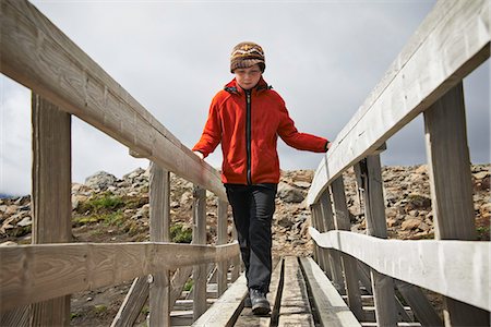 preteen hiking outdoors - Girl walking on wooden foot bridge Stock Photo - Premium Royalty-Free, Code: 649-06305456