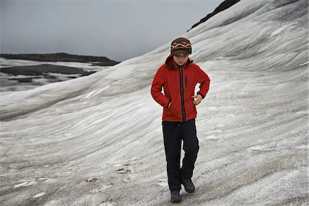 Girl walking on snowy hillside Stock Photo - Premium Royalty-Free, Code: 649-06305461