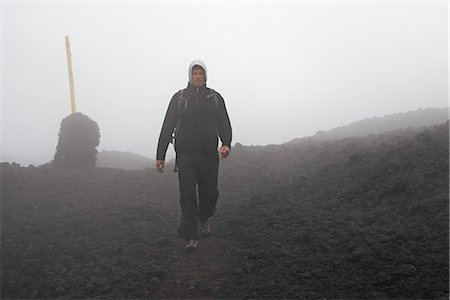 Man walking in rocky rural landscape Stock Photo - Premium Royalty-Free, Code: 649-06305471