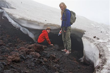 fun adventures weekend - Mother and daughter exploring snow drift Stock Photo - Premium Royalty-Free, Code: 649-06305472