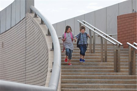 simsearch:649-06305517,k - Children climbing stairs outdoors Foto de stock - Sin royalties Premium, Código: 649-06305487