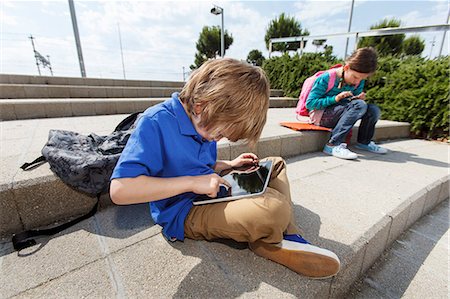 simsearch:649-07064289,k - Boy using tablet computer outdoors Stock Photo - Premium Royalty-Free, Code: 649-06305514