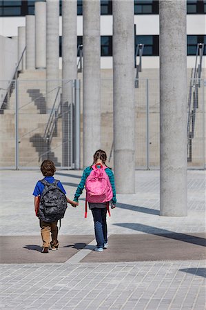 schoolgirls walking - Children holding hands in courtyard Stock Photo - Premium Royalty-Free, Code: 649-06305516