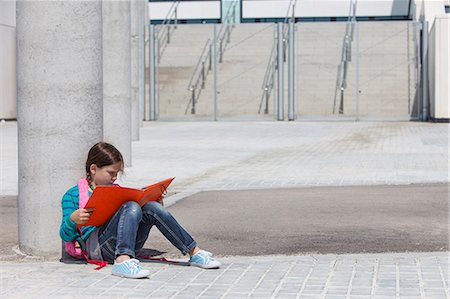 school girls brunette - Girl reading folder outdoors Stock Photo - Premium Royalty-Free, Code: 649-06305519