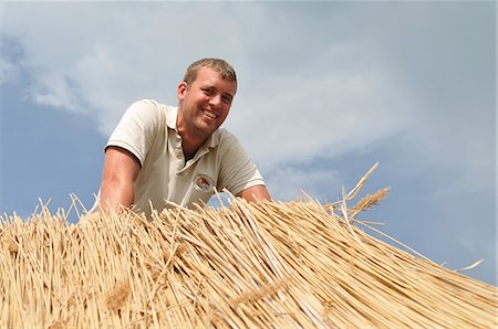 Man working on straw roof Stock Photo - Premium Royalty-Free, Code: 649-06305895