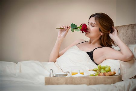 females smelling food - Woman relaxing with breakfast in bed Stock Photo - Premium Royalty-Free, Code: 649-06305917