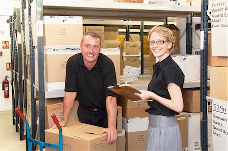 smiling blue collar guy - Workers talking in warehouse Stock Photo - Premium Royalty-Free, Code: 649-06305911