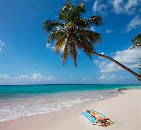 palm woman beach - Woman laying on towel on beach Stock Photo - Premium Royalty-Free, Code: 649-06352433