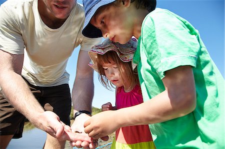 england beach one person - Father and children examining objects Stock Photo - Premium Royalty-Free, Code: 649-06352460