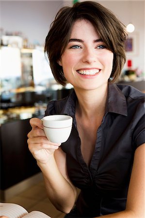 simsearch:649-06352545,k - Smiling woman having coffee in cafe Stock Photo - Premium Royalty-Free, Code: 649-06352539