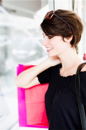 shopping and young women - Woman carrying shopping on city street Stock Photo - Premium Royalty-Free, Code: 649-06352555