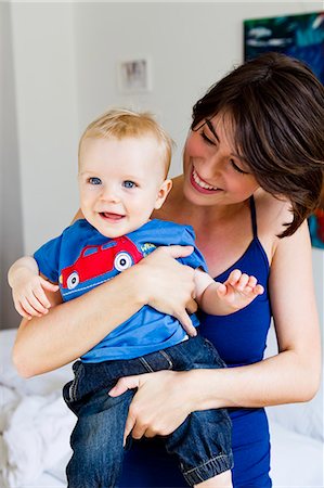 Mother holding baby in bedroom Stock Photo - Premium Royalty-Free, Code: 649-06352567