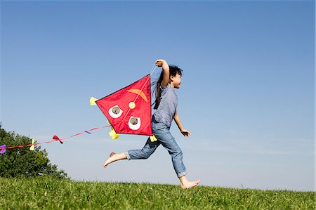 fly a kite - Girl playing with kite outdoors Stock Photo - Premium Royalty-Free, Code: 649-06352633