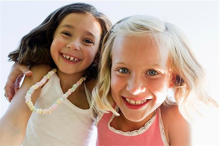 Close up of girls hugging outdoors Stock Photo - Premium Royalty-Free, Code: 649-06352668