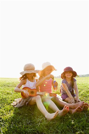 simsearch:649-06112676,k - Smiling girls relaxing in grass Stock Photo - Premium Royalty-Free, Code: 649-06352662