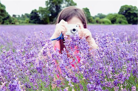 Girl taking pictures of flowers Stock Photo - Premium Royalty-Free, Code: 649-06352674