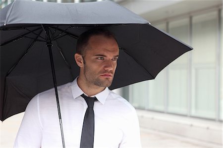 rainy london - Businessman walking under umbrella Stock Photo - Premium Royalty-Free, Code: 649-06352704