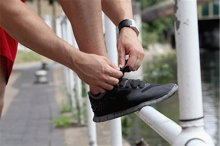 shoe lifestyle - Close up of runner tying laces Stock Photo - Premium Royalty-Free, Code: 649-06352719