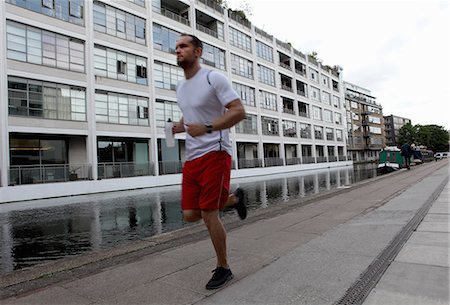 fit person running - Man running on city street Stock Photo - Premium Royalty-Free, Code: 649-06352725