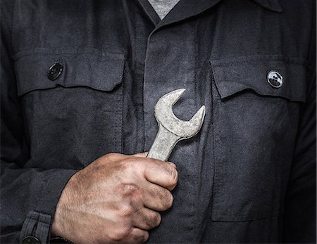 Close up of worker holding wrench Stock Photo - Premium Royalty-Free, Code: 649-06352767