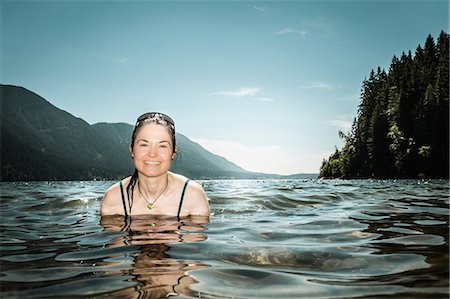 swimming in the lake - Woman standing in still lake Stock Photo - Premium Royalty-Free, Code: 649-06352774