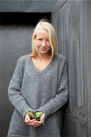 protection looking at camera - Teenage girl holding seedling Stock Photo - Premium Royalty-Free, Code: 649-06352949