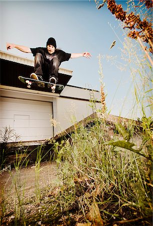 skateboarder - Man skating on grassy concrete Stock Photo - Premium Royalty-Free, Code: 649-06352976