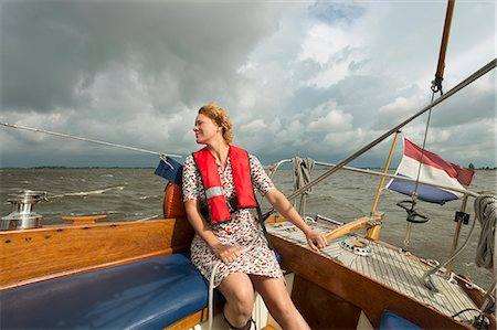 simsearch:6122-07695038,k - Woman steering boat on rocky water Foto de stock - Royalty Free Premium, Número: 649-06353007