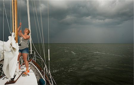 people of holland - Woman hoisting rigging on boat Stock Photo - Premium Royalty-Free, Code: 649-06353014