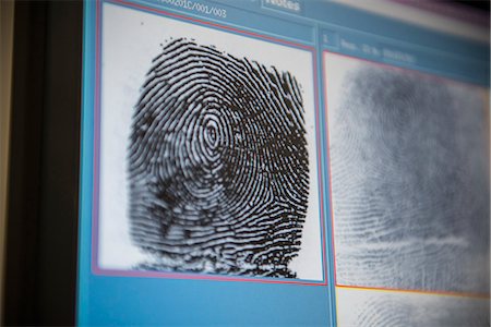 Fingerprints on screen in forensic lab Stock Photo - Premium Royalty-Free, Code: 649-06353094
