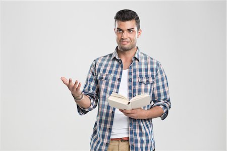 dialog - Man gesturing and reading book Stock Photo - Premium Royalty-Free, Code: 649-06353178