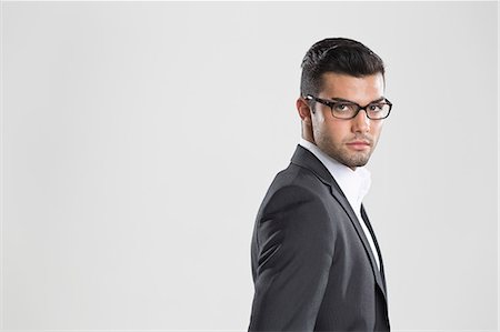 stubble - Businessman looking over his shoulder Stock Photo - Premium Royalty-Free, Code: 649-06353184