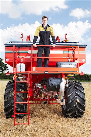 Farmer standing on tractor in field Stock Photo - Premium Royalty-Free, Code: 649-06353329