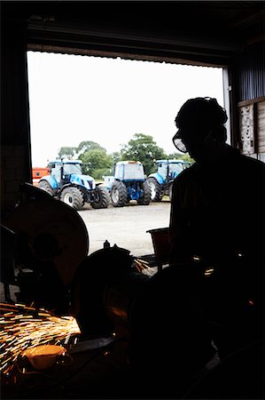 Silhouette of metal worker in shop Stock Photo - Premium Royalty-Free, Code: 649-06353333