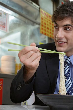 single men dining alone pictures - Businessman eating noodles in cafe Stock Photo - Premium Royalty-Free, Code: 649-06353473