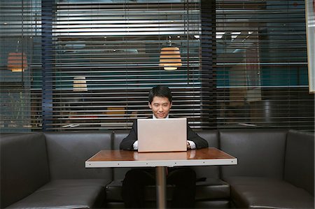 Businessman using laptop in cafe Stock Photo - Premium Royalty-Free, Code: 649-06353480