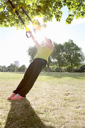 Woman using exercise straps outdoors Stock Photo - Premium Royalty-Free, Code: 649-06400470
