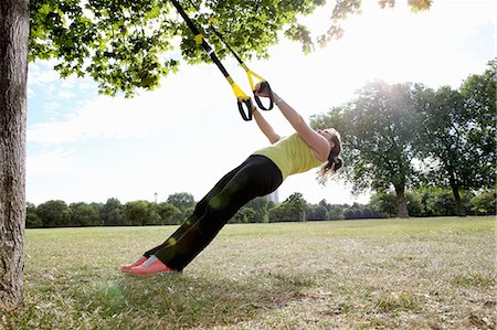 Woman using exercise straps outdoors Stock Photo - Premium Royalty-Free, Code: 649-06400472