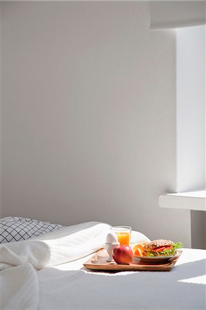 Plateau de nourriture petit déjeuner sur le lit Photographie de stock - Premium Libres de Droits, Code: 649-06400710