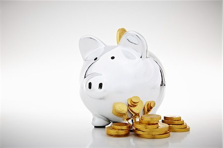 finance - Stack of gold coins by piggy bank Stock Photo - Premium Royalty-Free, Code: 649-06400879