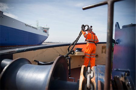 port (seaport) - Worker on tug boat holding rope Stock Photo - Premium Royalty-Free, Code: 649-06400909