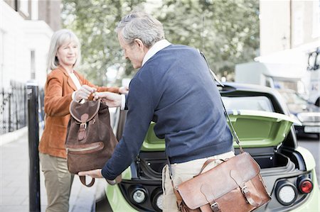 sustainable transportation - Couple loading car on city street Stock Photo - Premium Royalty-Free, Code: 649-06401097