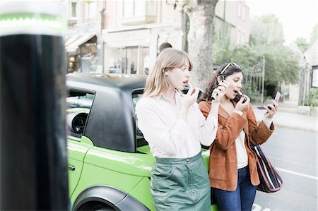 electric car - Women applying lipstick on city street Stock Photo - Premium Royalty-Free, Code: 649-06401128